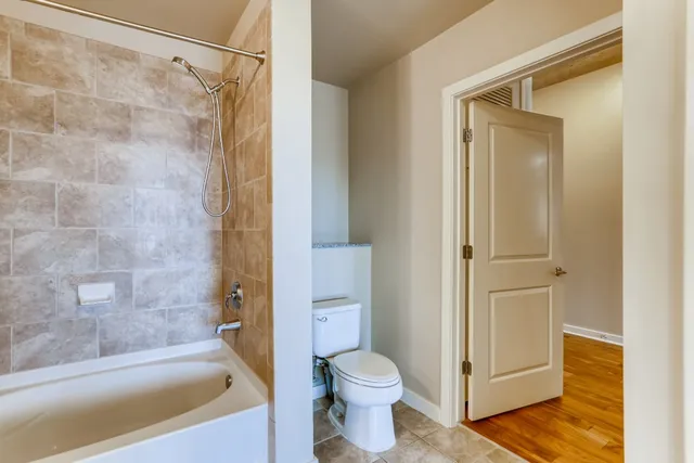 a bathroom with a shower and a toilet