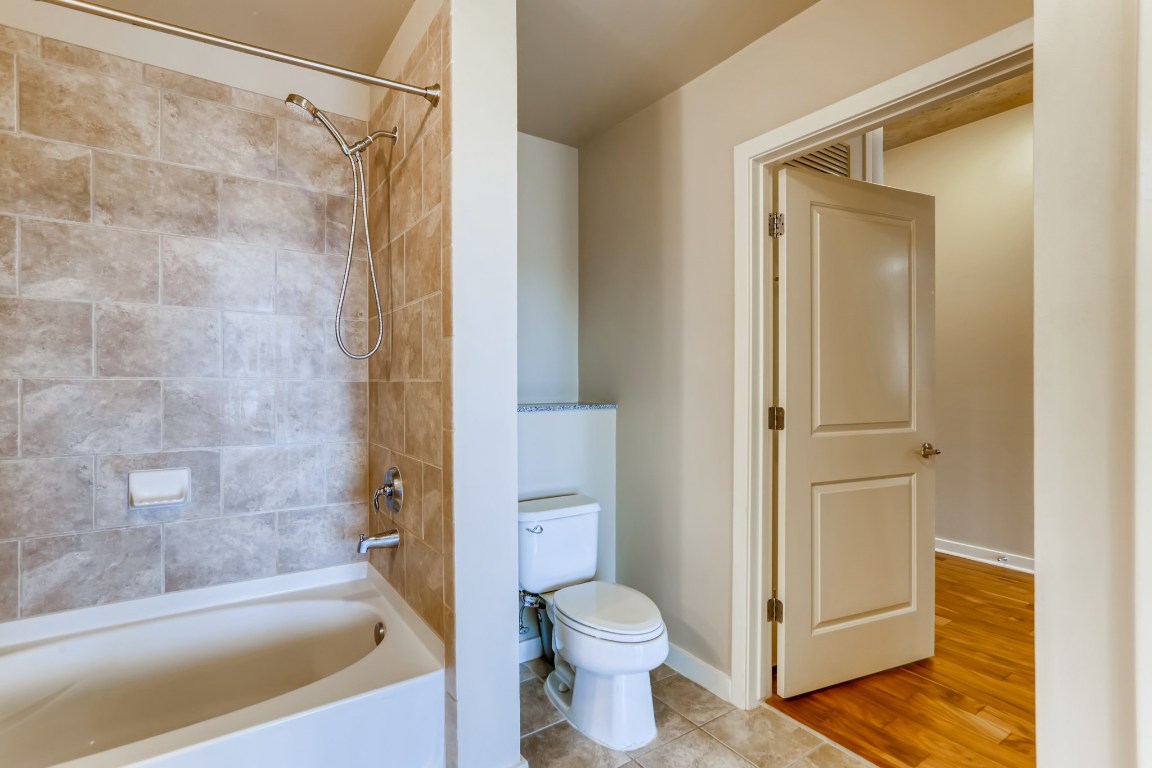 360 Nueces Street, Unit 2607 Austin, TX 78701 - Photo 19 of 23 a bathroom with a shower and a toilet