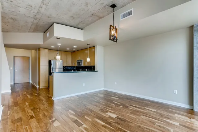 a view of a hallway with a kitchen