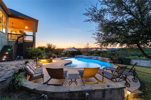 an outdoor space with pool and furniture