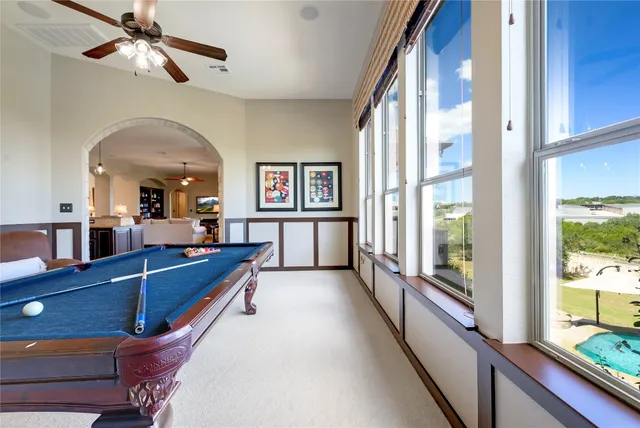 a view of a room with furniture and a large window