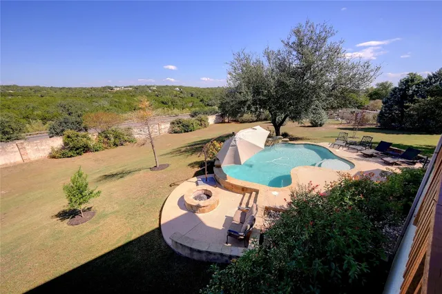 an aerial view of a house with outdoor space swimming pool and lake view