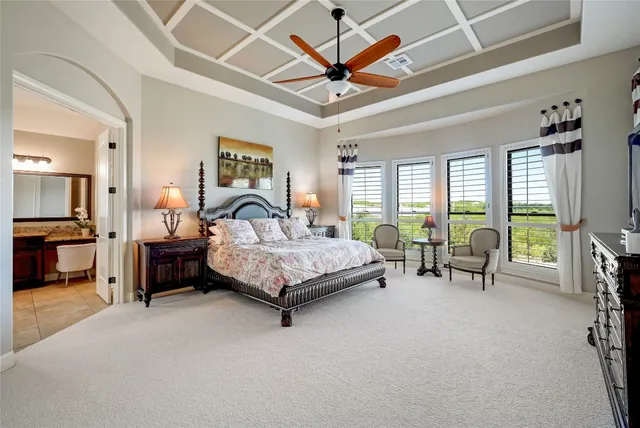 a bedroom with a bed a table and chairs