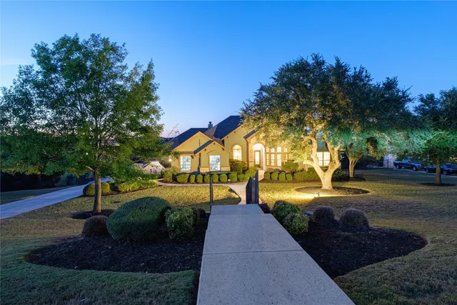 a view of a house with backyard and a tree