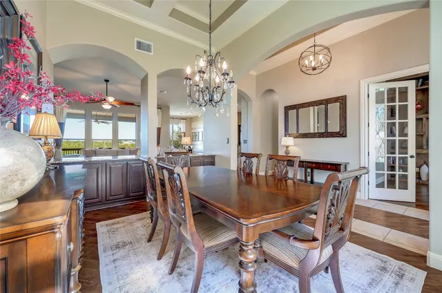 a view of a dining room with furniture and chandelier