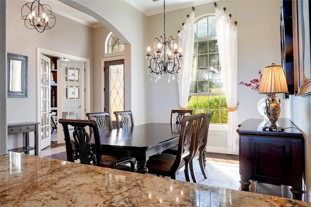 a view of a dining room with furniture and chandelier