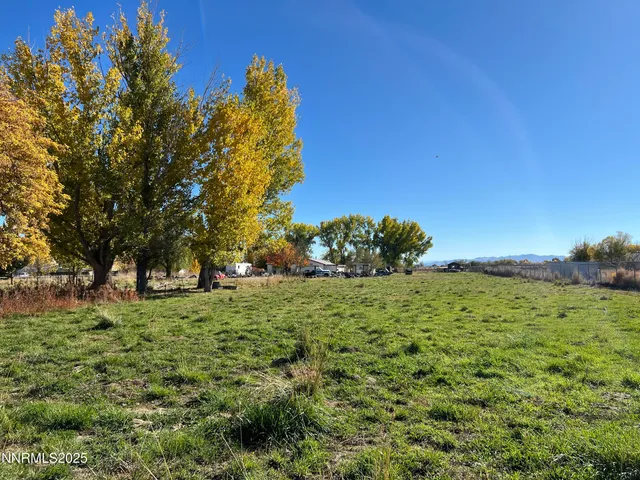 a view of a big yard with a house