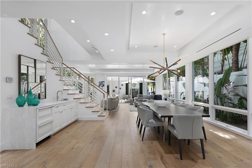 a view of a dining room with furniture wooden floor and chandelier