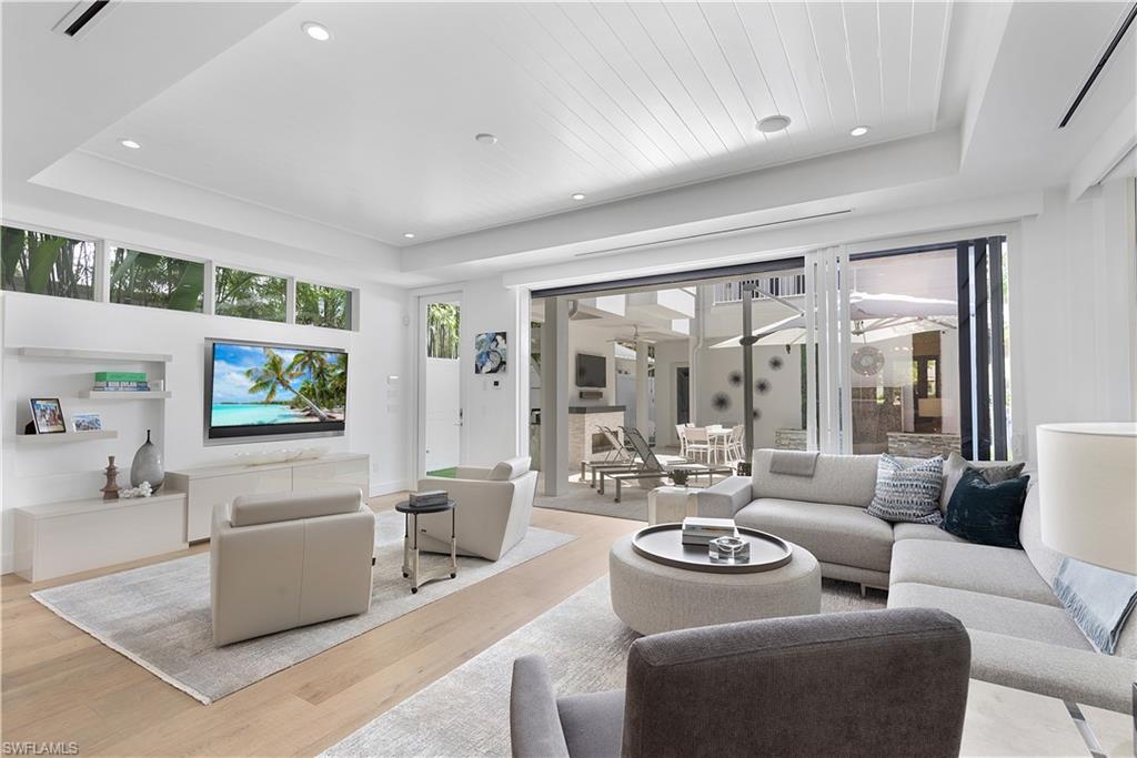 1021 6th Street South Naples, FL 34102 - Photo 10 of 44 a living room with furniture and a flat screen tv