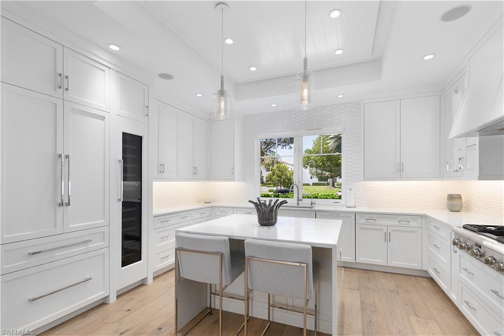 1021 6th Street South Naples, FL 34102 - Photo 12 of 44 a kitchen with a sink cabinets and window