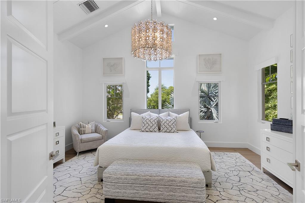 1021 6th Street South Naples, FL 34102 - Photo 18 of 44 a bedroom with a large bed and a window