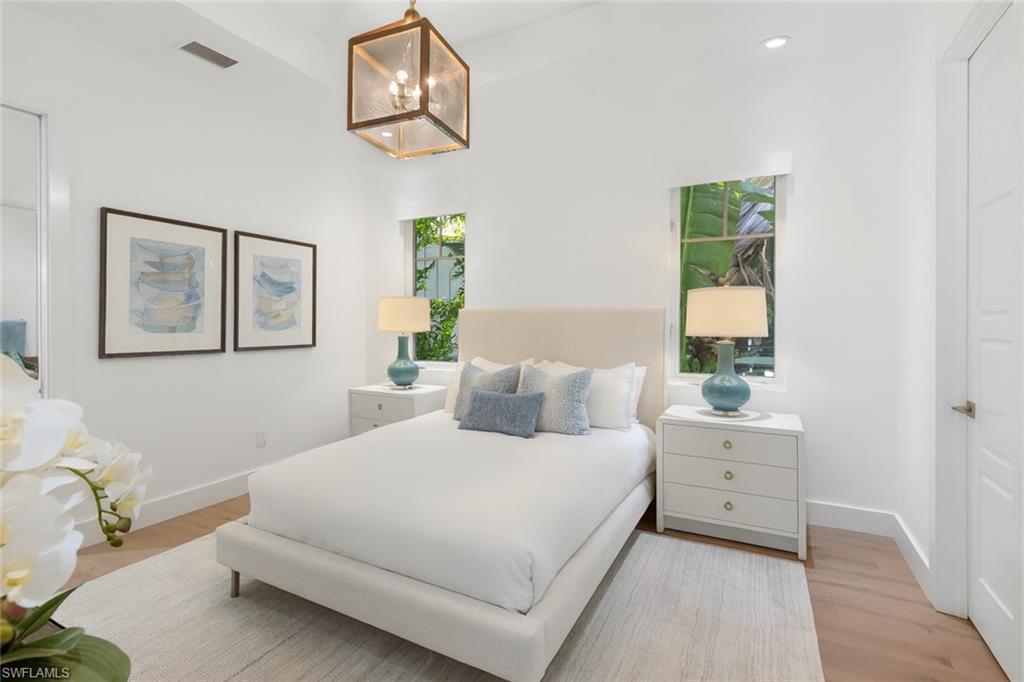 1021 6th Street South Naples, FL 34102 - Photo 23 of 44 a bedroom with a bed and a window