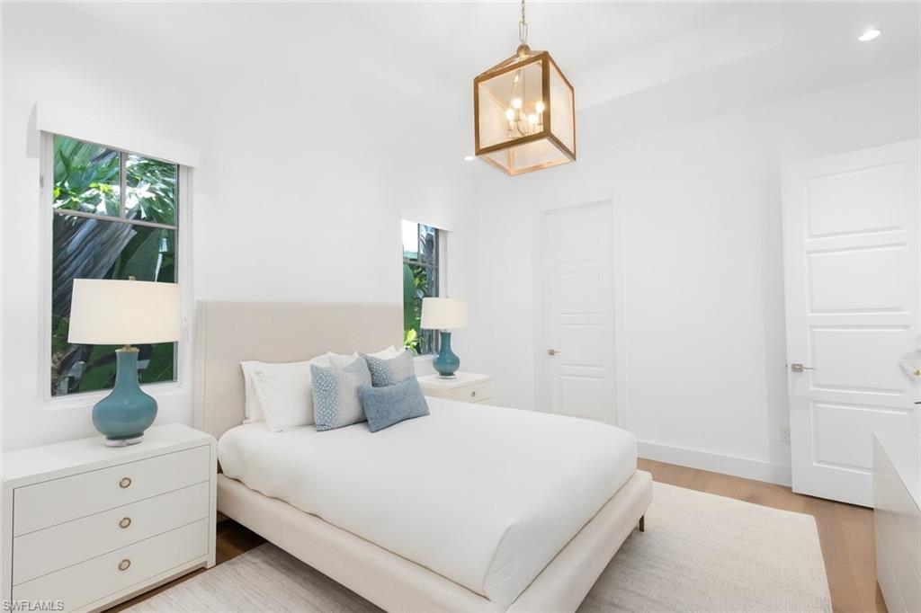 1021 6th Street South Naples, FL 34102 - Photo 24 of 44 a bedroom with a bed and a dresser