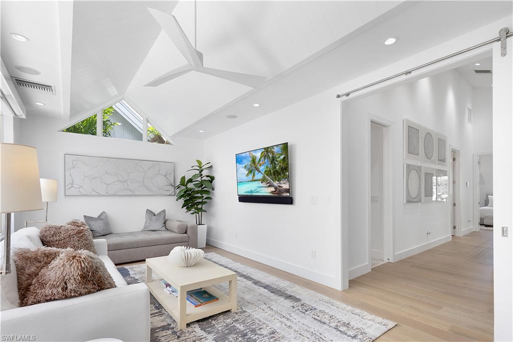 1021 6th Street South Naples, FL 34102 - Photo 28 of 44 a living room with furniture and wooden floor