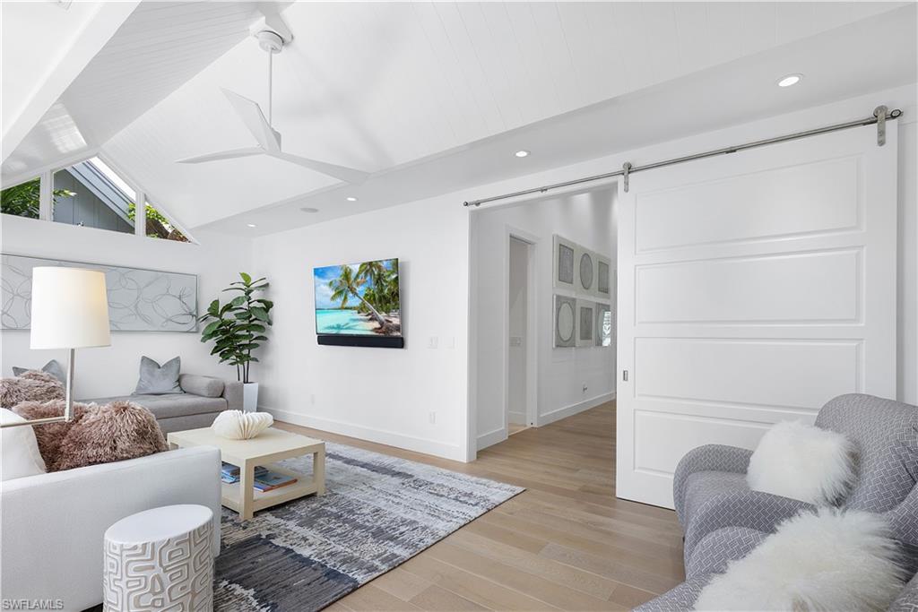 1021 6th Street South Naples, FL 34102 - Photo 29 of 44 a living room with furniture and wooden floor