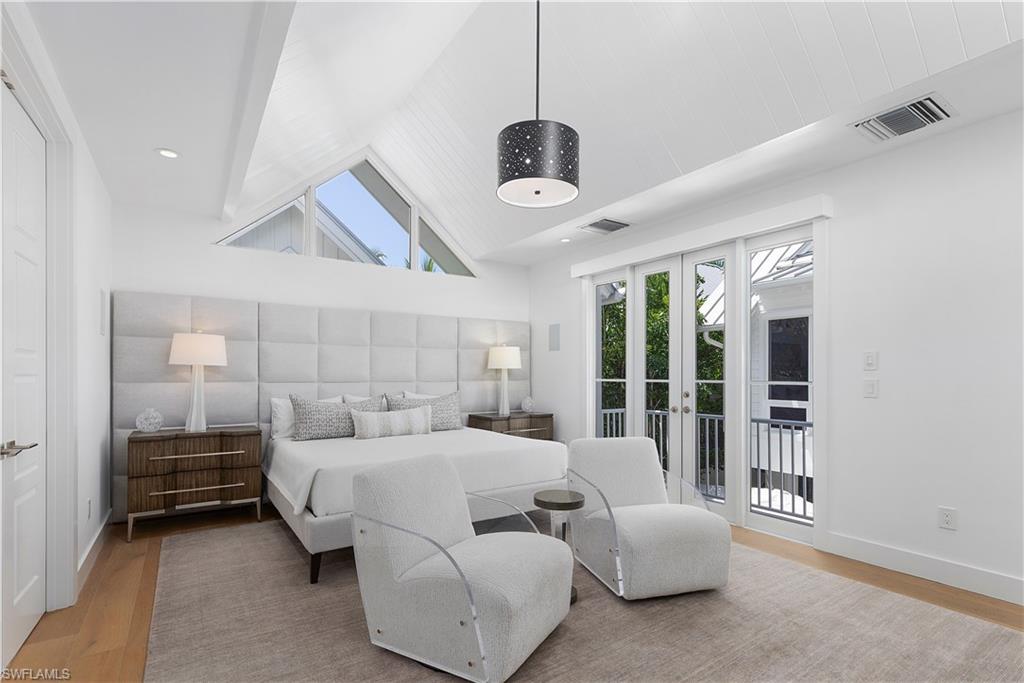 1021 6th Street South Naples, FL 34102 - Photo 32 of 44 a bedroom with furniture and large windows