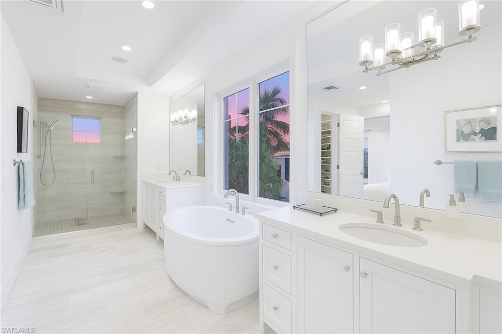 1021 6th Street South Naples, FL 34102 - Photo 35 of 44 a bathroom with a sink a toilet a mirror and shower