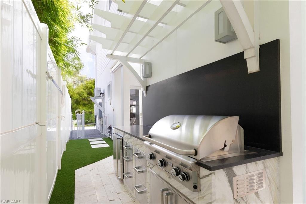 1021 6th Street South Naples, FL 34102 - Photo 38 of 44 a front view of a house with a garden