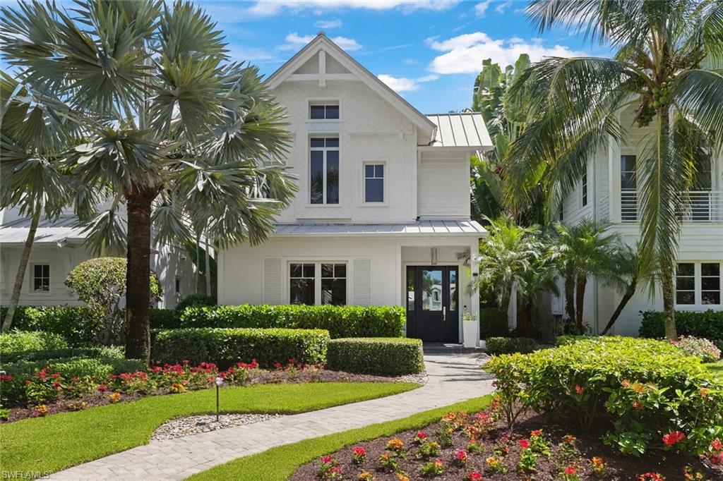 1021 6th Street South Naples, FL 34102 - Photo 43 of 44 a view of a white house with a big yard and potted plants