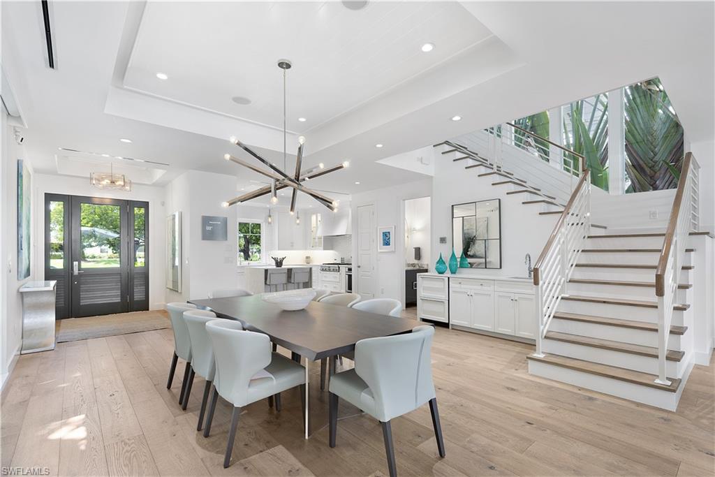 1021 6th Street South Naples, FL 34102 - Photo 4 of 44 a view of a dining room with furniture and wooden floor