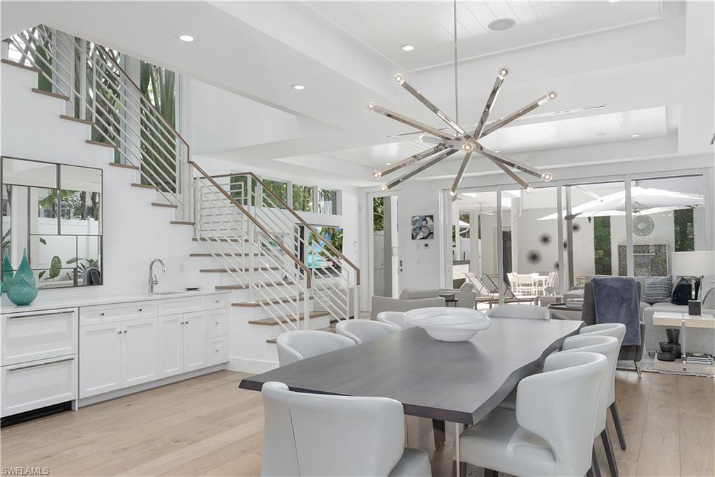 1021 6th Street South Naples, FL 34102 - Photo 5 of 44 a dining room with furniture and wooden floor