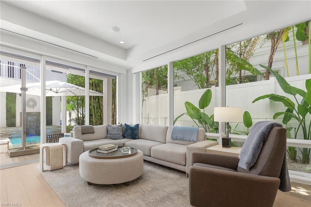 1021 6th Street South Naples, FL 34102 - Photo 7 of 44 a living room with furniture and a large window