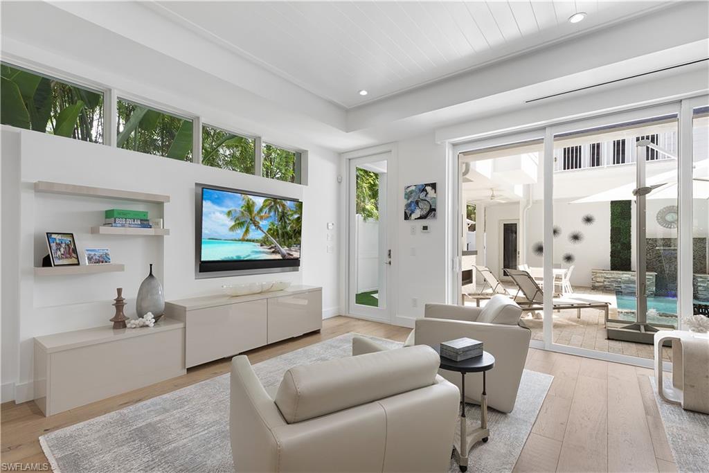 1021 6th Street South Naples, FL 34102 - Photo 8 of 44 a living room with furniture and a flat screen tv