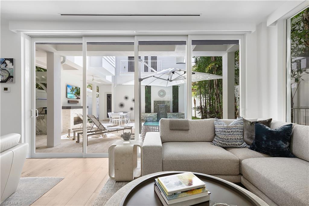 1021 6th Street South Naples, FL 34102 - Photo 9 of 44 a living room with furniture and a large window