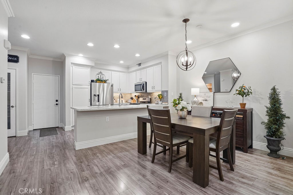 7701 Chambray Place, Unit 3 Rancho Cucamonga, CA 91739 - Photo 11 of 52 a kitchen with a table and chairs in it
