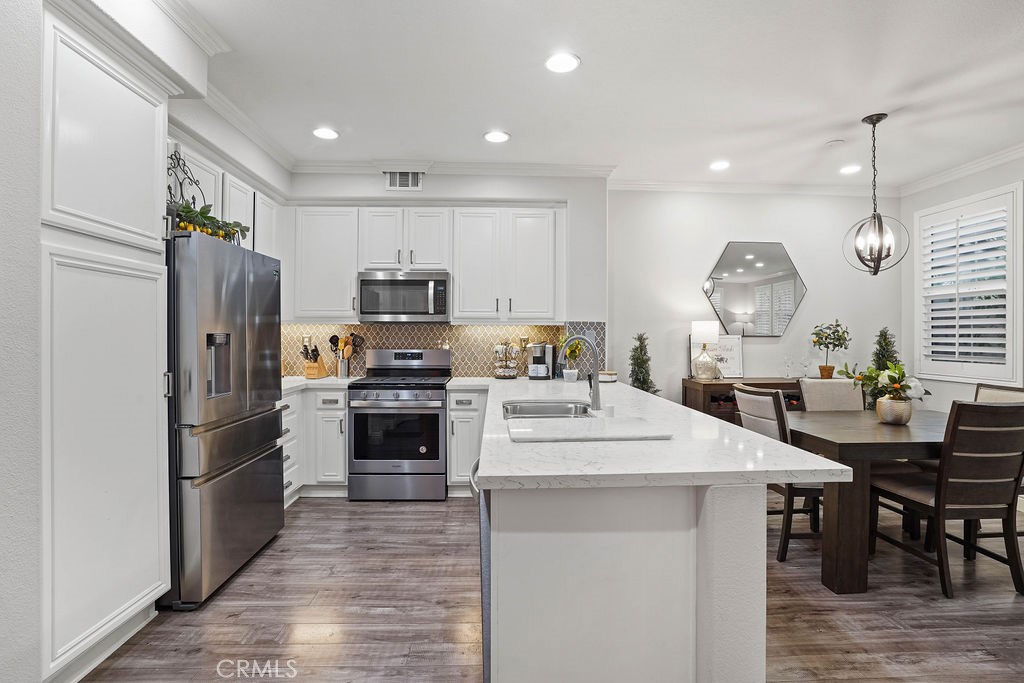 7701 Chambray Place, Unit 3 Rancho Cucamonga, CA 91739 - Photo 15 of 52 a kitchen with a sink stainless steel appliances and white cabinets