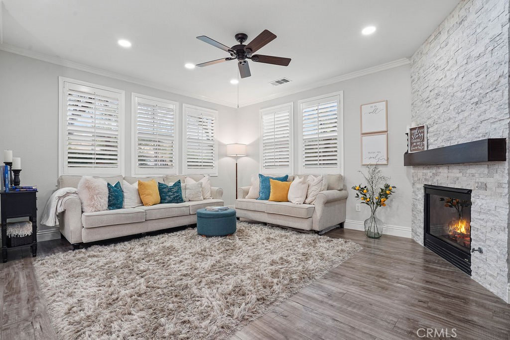 7701 Chambray Place, Unit 3 Rancho Cucamonga, CA 91739 - Photo 16 of 52 a living room with furniture a fireplace and a large window