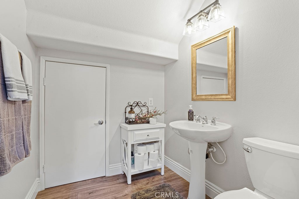 7701 Chambray Place, Unit 3 Rancho Cucamonga, CA 91739 - Photo 19 of 52 a bathroom with a toilet sink and mirror