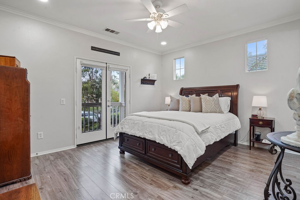 7701 Chambray Place, Unit 3 Rancho Cucamonga, CA 91739 - Photo 24 of 52 a bedroom with a large bed chandelier and a window