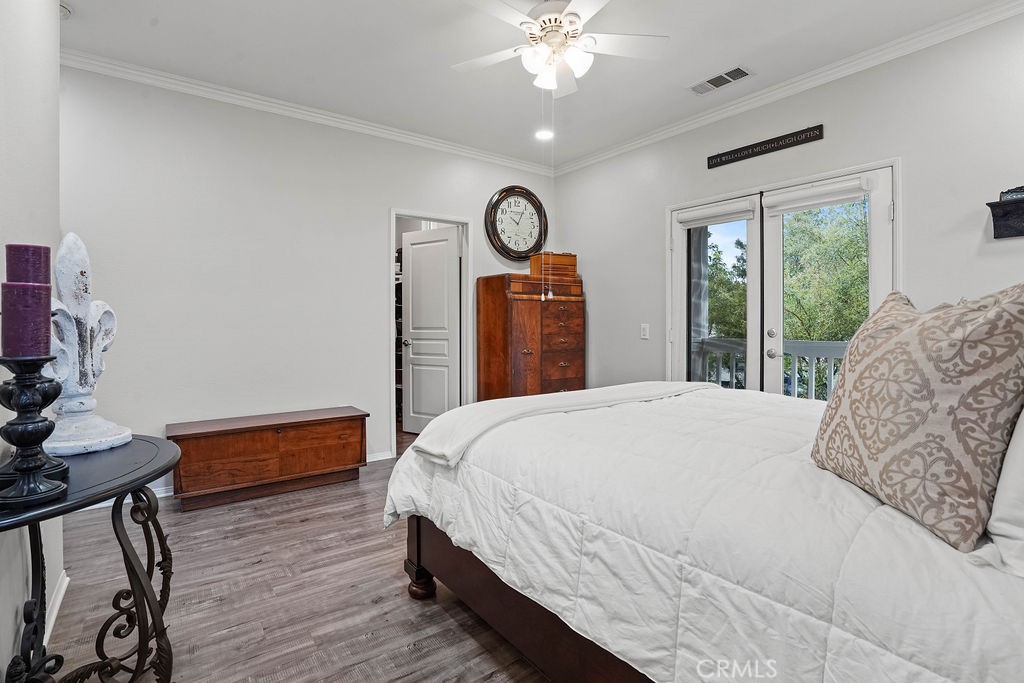 7701 Chambray Place, Unit 3 Rancho Cucamonga, CA 91739 - Photo 26 of 52 a bedroom with a bed and a chandelier