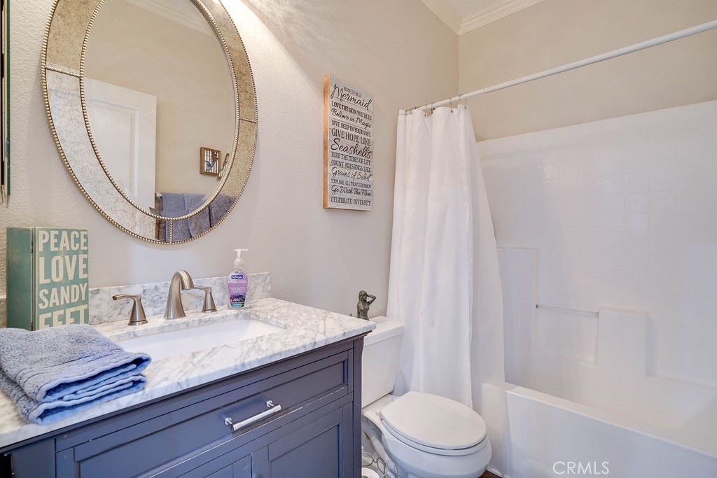 7701 Chambray Place, Unit 3 Rancho Cucamonga, CA 91739 - Photo 33 of 52 a bathroom with a granite countertop sink a toilet and a mirror