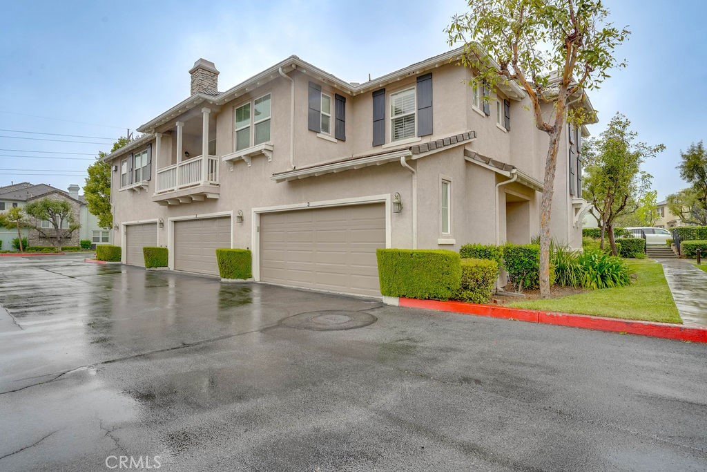 7701 Chambray Place, Unit 3 Rancho Cucamonga, CA 91739 - Photo 34 of 52 a view of a house with a yard and large tree