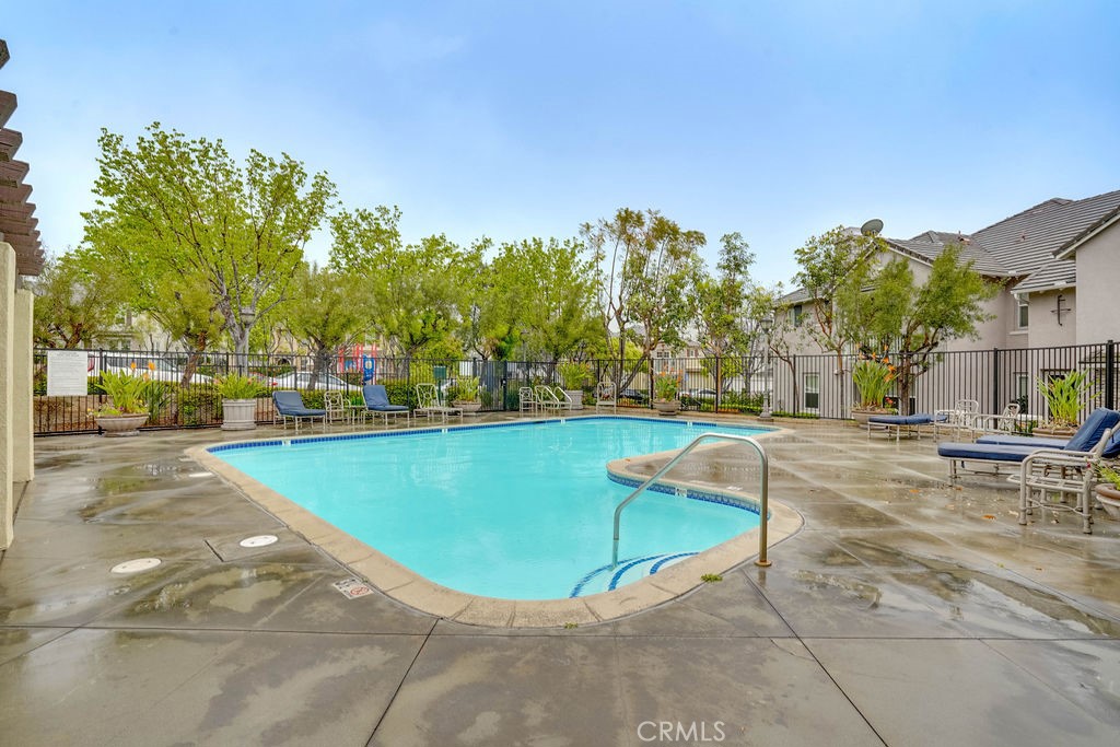 7701 Chambray Place, Unit 3 Rancho Cucamonga, CA 91739 - Photo 45 of 52 a view of a swimming pool with an outdoor seating and a garden