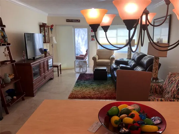 a living room with furniture a air conditioner and a fireplace