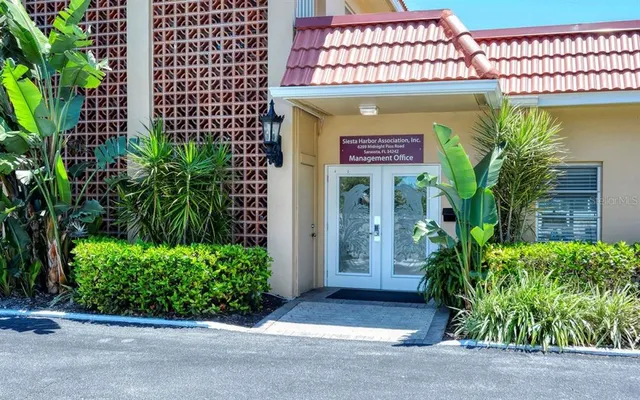 a view of a swimming pool with a garden and seating space