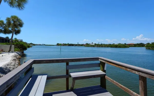 a view of a lake with houses in the back