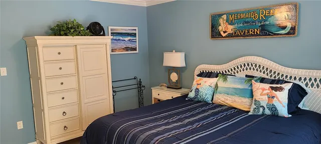 a bedroom with a bed and a dresser