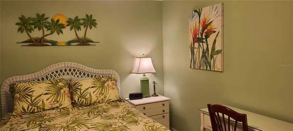 a bedroom with a bed and a chair