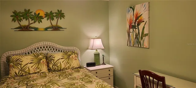 a bedroom with a bed and a chair