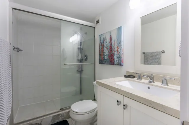 a view of a house with a small yard and wooden floor and fence