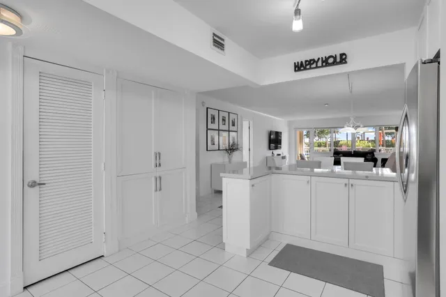 a kitchen with stainless steel appliances kitchen island granite countertop a refrigerator and a stove top oven