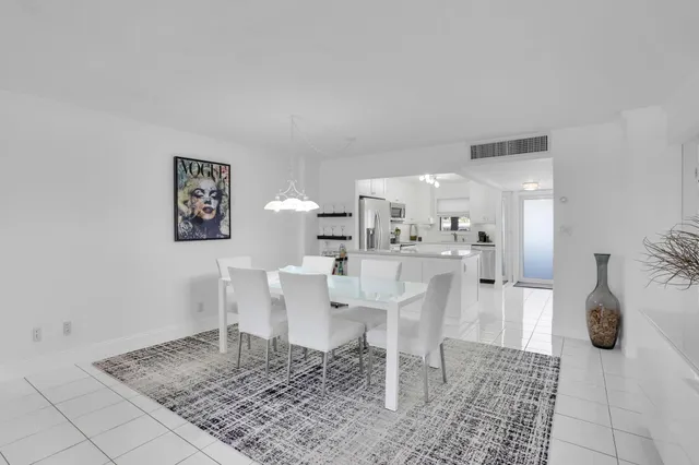 a living room with fireplace furniture and a rug