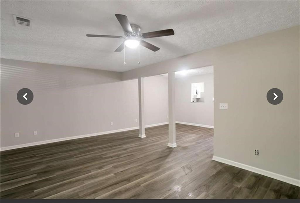 3833 Waldrop Lane Decatur, GA 30034 - Photo 3 of 20 an empty room with wooden floor and windows