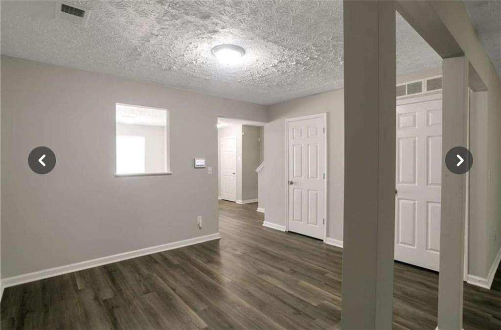 3833 Waldrop Lane Decatur, GA 30034 - Photo 8 of 20 an empty room with wooden floor and windows