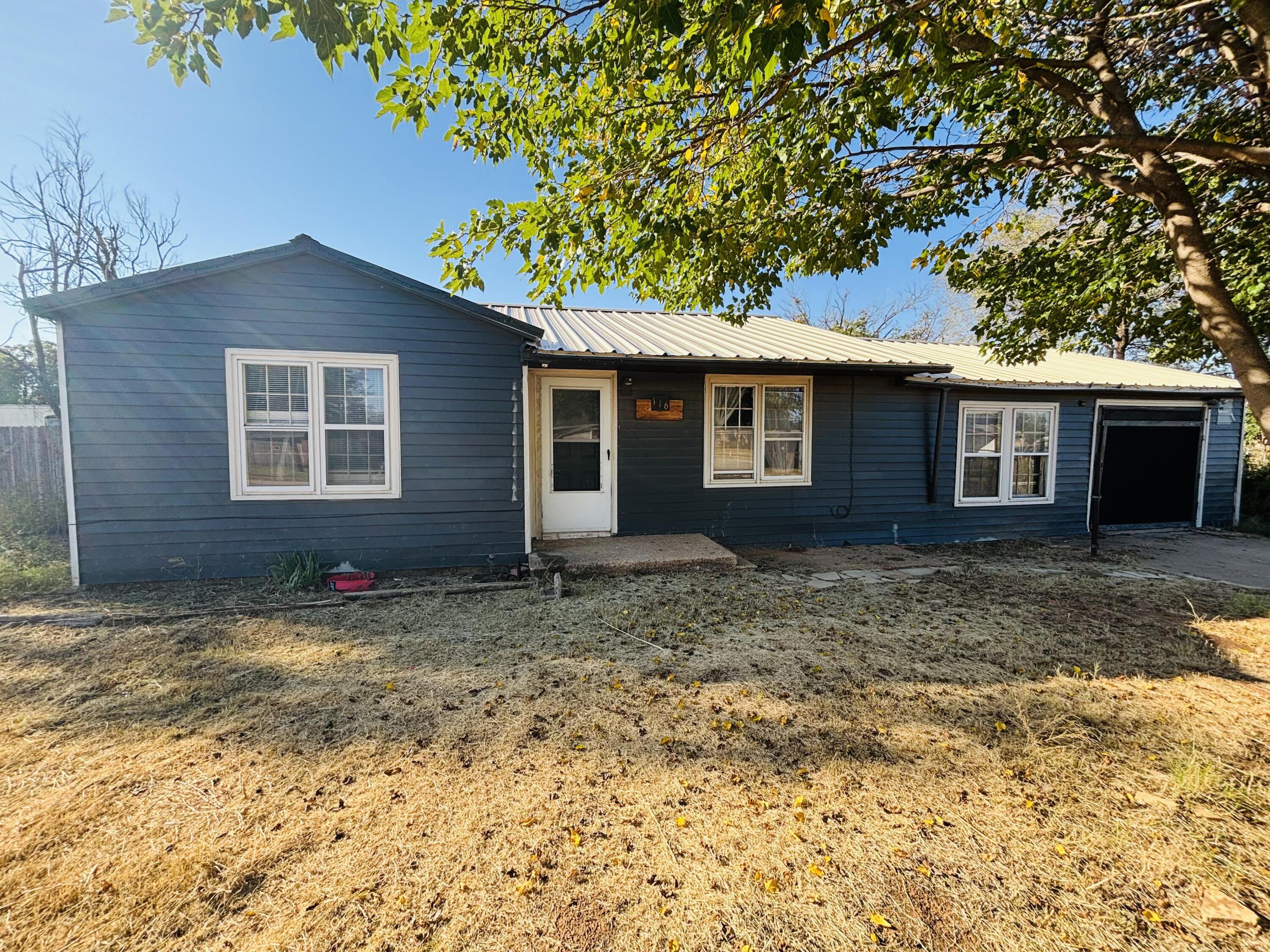116 East 75th Street Lubbock, TX 79404 - Photo 2 of 2 a house with trees in the background