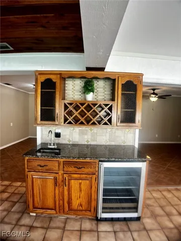 a kitchen with stainless steel appliances granite countertop a refrigerator and a stove